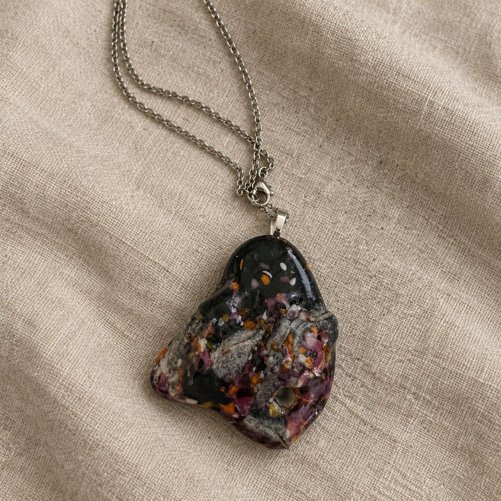 Dark triangular glass pendant with multicolored speckles on a silver-tone chain