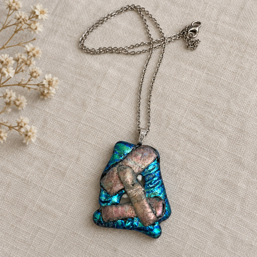 Turquoise and pink layered glass pendant on a silver-tone chain