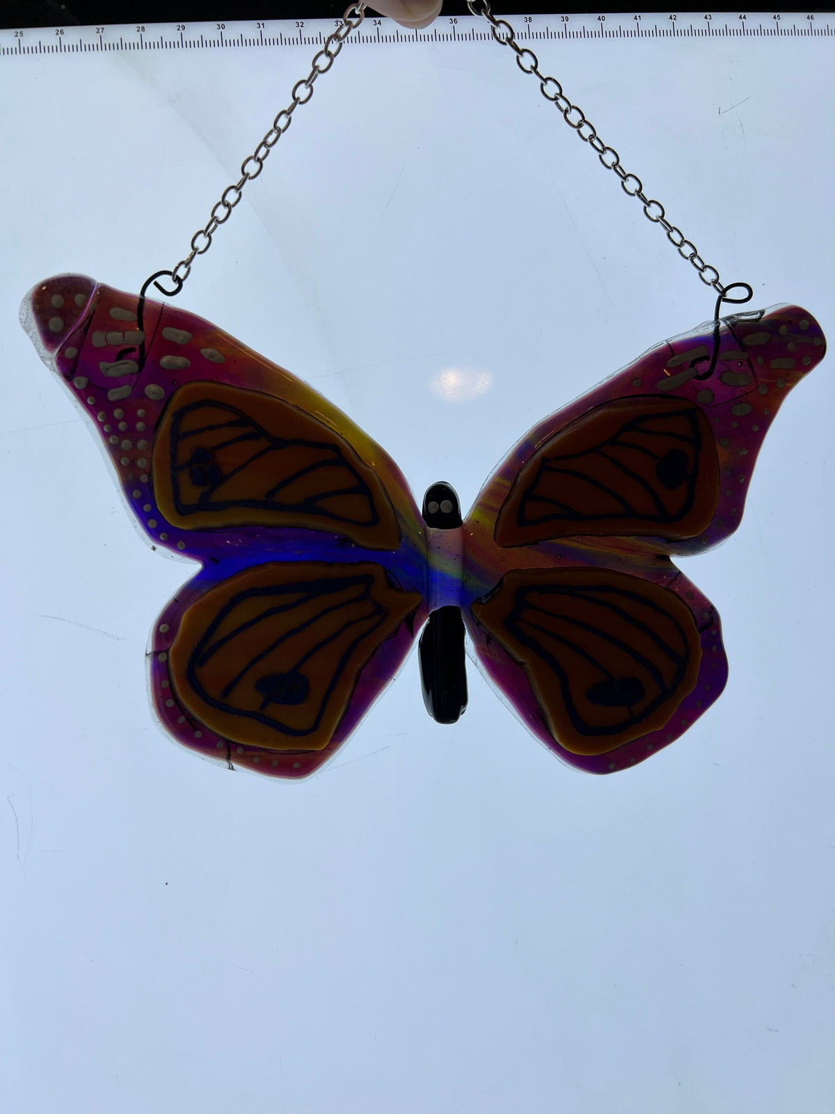 Monarch butterfly stained glass suncatcher on a light table