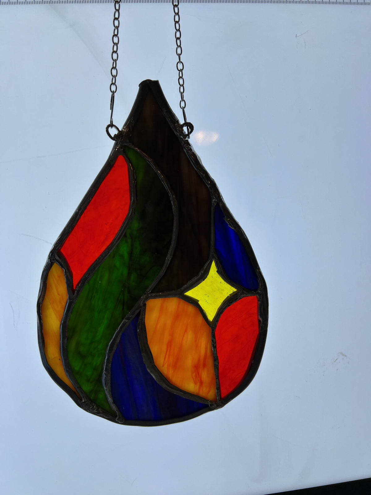 Abstract teardrop stained glass suncatcher in red, orange, green and blue