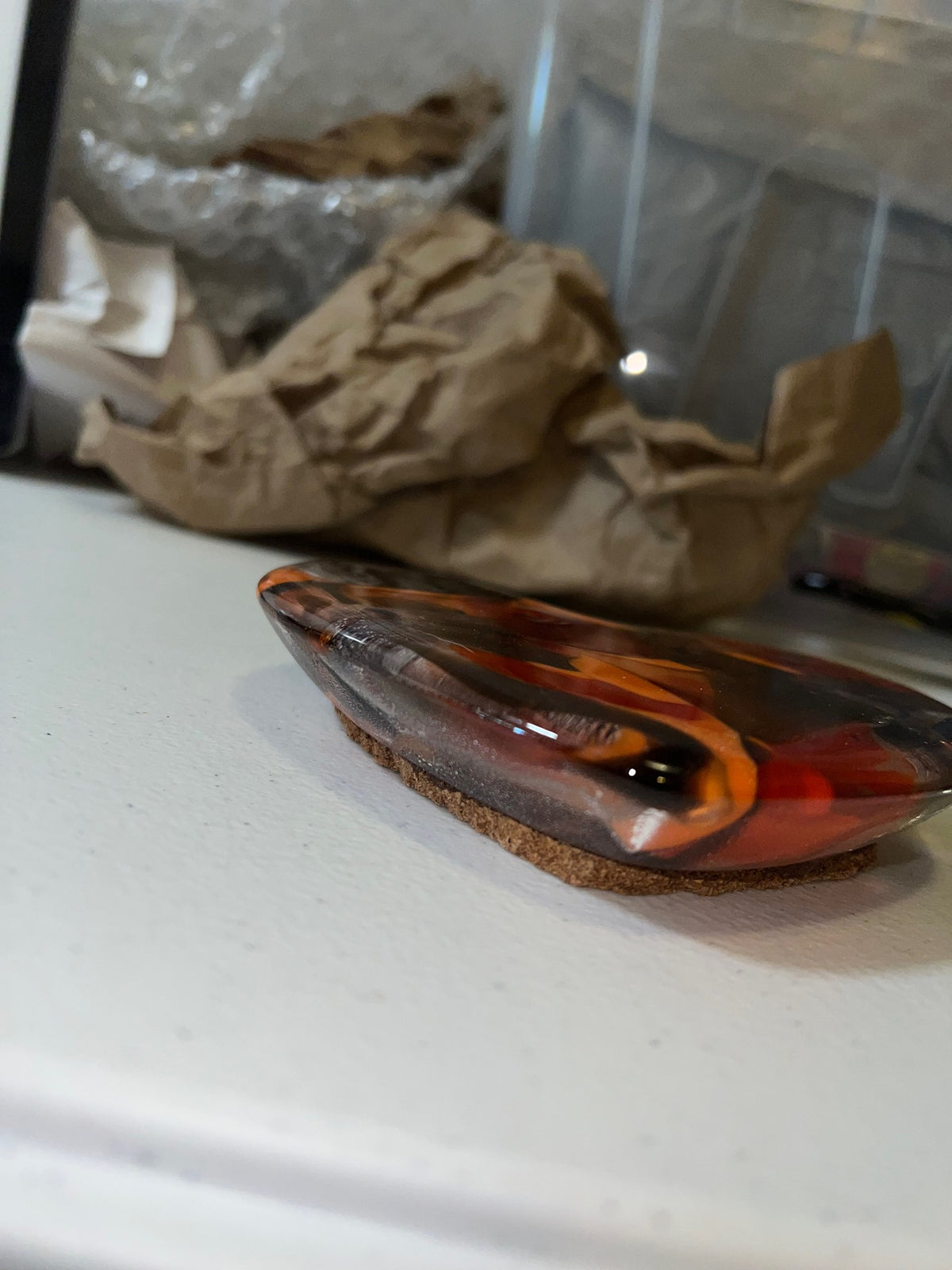 Red, orange and purple fused glass heart paperweight, side view