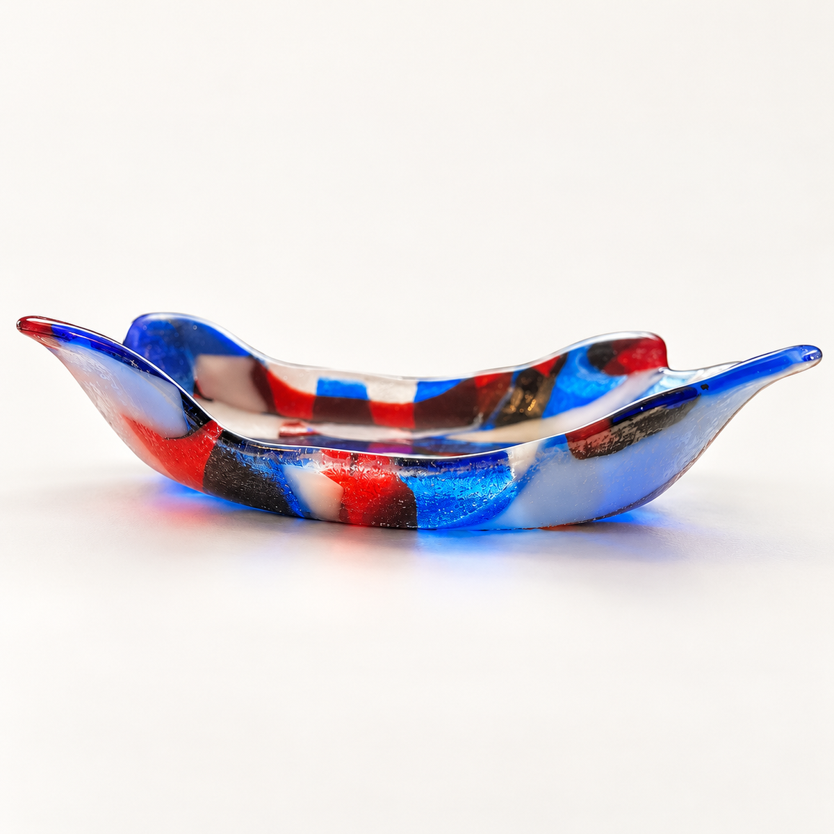 Side view showing the lifted sculptural edges of the fused glass dish